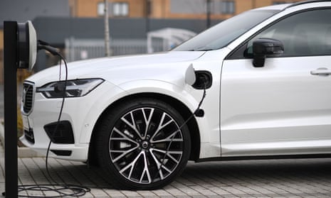 A Volvo XC60 hybrid car plugged into a charging point outside a dealership in Reading