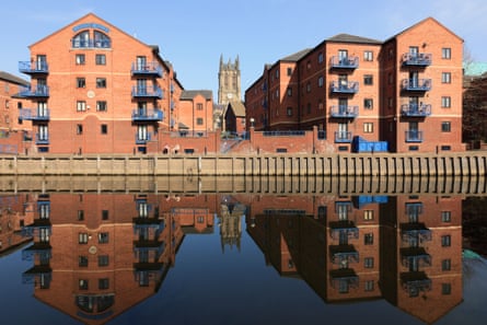 Waterfront apartments in Leeds are reflected in the river