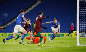 Brighton & Hove Albion’s Dan Burn scores an own goal.