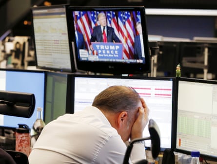 A broker reacts as President-elect Donald Trump appears on a television screen at the stock market in Frankfurt, Germany.