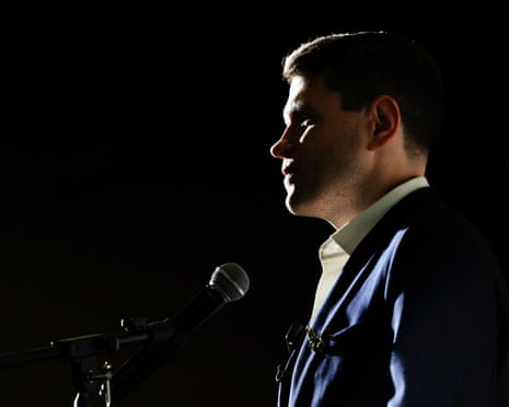 a man stands by a microphone