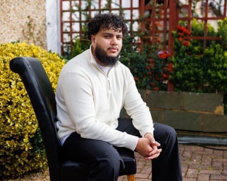 A man sitting on a chair outside.