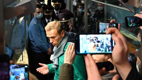 Alexei Navalny detained after arriving at airport on return to Russia – video