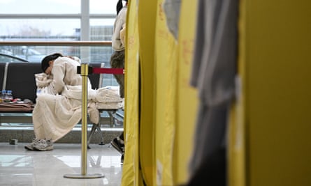 A relative of passengers reacts near a makeshift shelter at Muan international airport