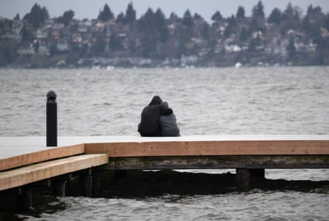 A couple gazes over Lake Washington on March 14, 2020 in Kirkland, Washington. As the coronavirus pandemic has spread, officials have advised social distancing from crowds to avoid contracting COVID-19. 