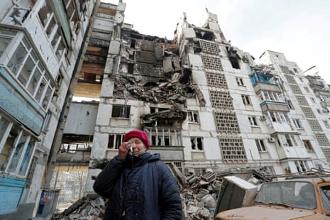 Local resident Valentina Demura, 70, next to the building where her apartment is located in the besieged southern port city of Mariupol, Ukraine March 27, 2022.