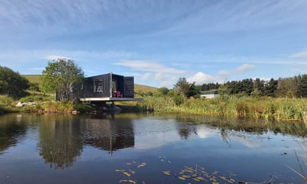 Cantilevered shipping container over water