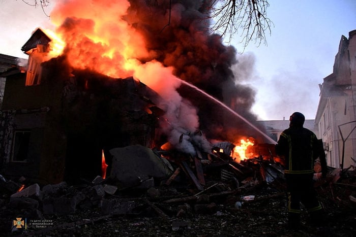 A firefighter works at a site of a residential building damaged by a Russian military strike in Mykolaiv, Ukraine, 12 July.