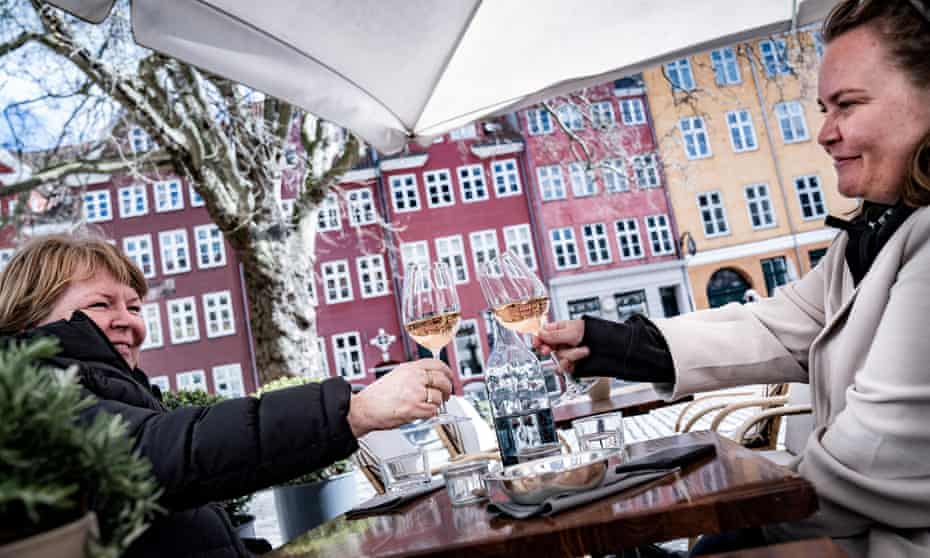 Guests enjoy a glass of wine outside a cafe as the coronavirus restrictions ease in Copenhagen.