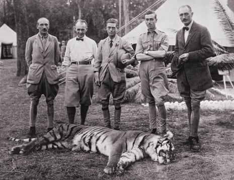 The then Prince of Wales, centre, poses with a tiger he shot on a hunting expedition in Nepal, 1922.