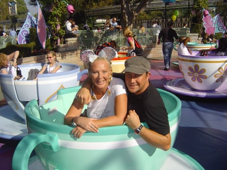 The couple in a teacup ride, with Samantha wearing mouse ears