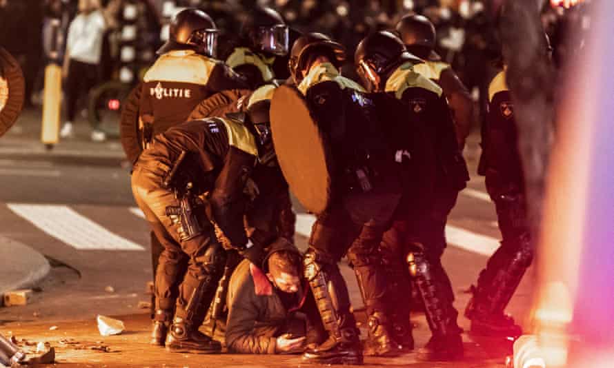Police detain a protester.