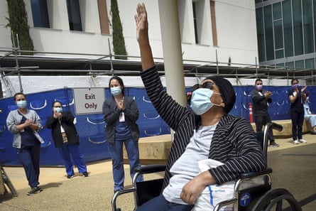 Karen Parker-Bryant, 64, raises a hand skyward after she was released from Clovis community hospital in Fresno, California, in May, after a month-and-a-half battle with Covid-19.