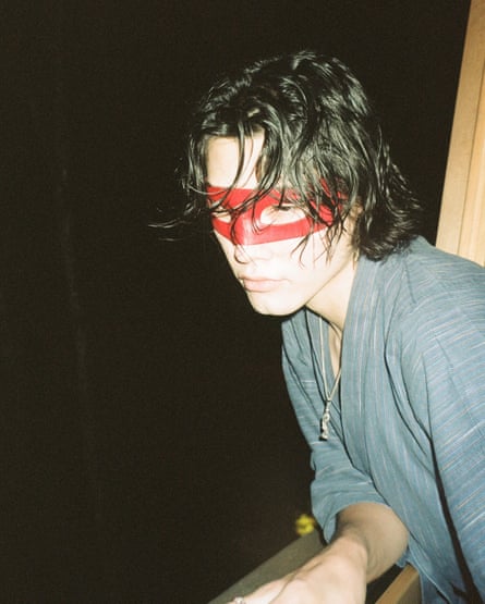 Lewis with a red mask across his eyes