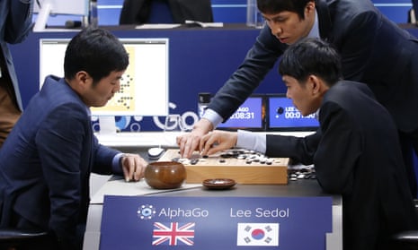 Go player Lee Sedol, seated right, reviews the game after losing to AlphaGo.