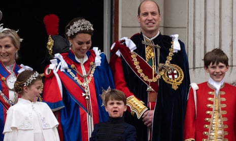 Prince Louis (centre) watches the Red Arrow flypast from the balcony of Buckingham Palace.