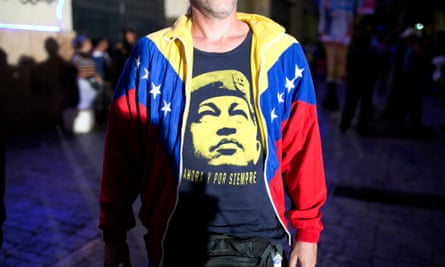 A pro-government supporter wears a T-Shirt with image of Venezuela’s late President Hugo Chavez, as he waits for resultsof the elections in Caracas.