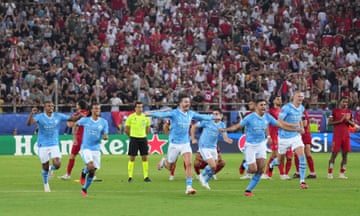 Manchester City players celebrate following the team's victory in the penalty shootout.