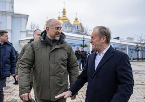 Polish Prime Minister Donald Tusk and his Ukrainian counterpart Denys Shmyhal walk at Mykhailivksa Square after visiting the Memory Wall of Fallen Defenders of Ukraine.