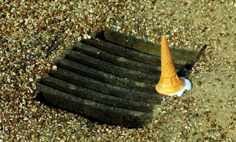 Discarded dropped ice-cream cornet on a drain.