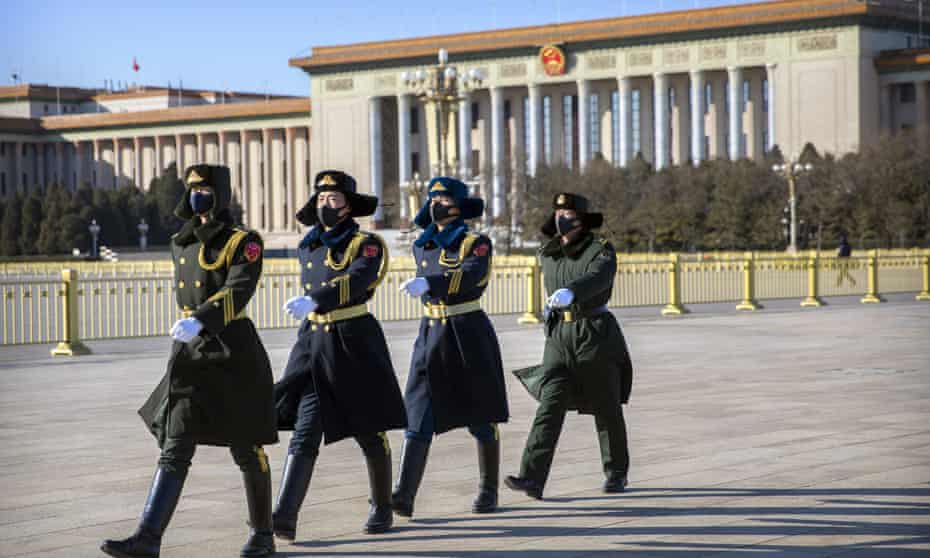 Chinese guards wear face masks as they march in  Tiananmen Square in Beijing.