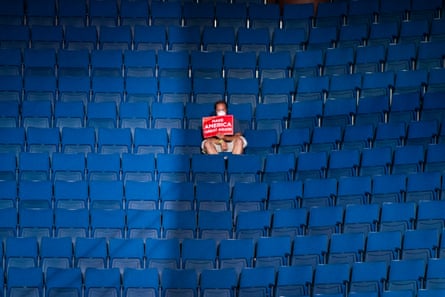 A supporter sits alone in the top sections of seating as Mike Pence speaks before Trump arrives for a rally at the BOK Center in Tulsa, Oklahoma, in June.