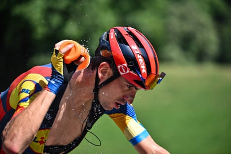 Giulio Ciccone douses himself with water to cool down as he cycles in a breakaway during the 14th stage the Tour de France.