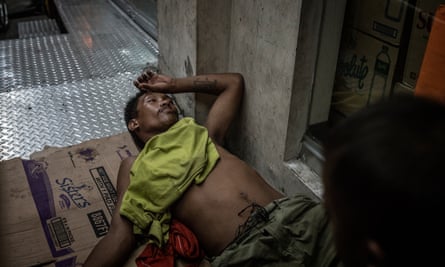 A man under the influence of drugs has passed out in front of a store entrance, a highly dangerous thing to do in Navotas. where there have been dozens of extrajudicial killings since the beginning of Duterte’s “Tokhang” drug war