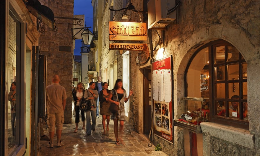 Visitors take an evening stroll in Budva