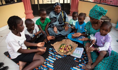 Oumie Sissokho, an FGM activist in the Gambia, prepares to discuss the practice with a family