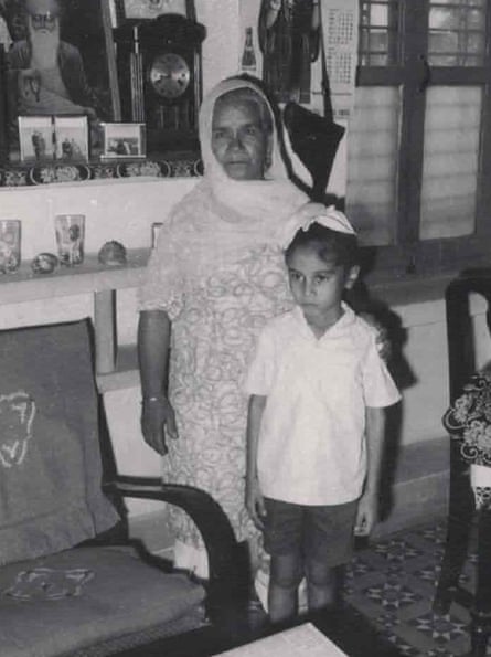 A b&w shot of young Avtar with his grandmother standing next to each other in a room