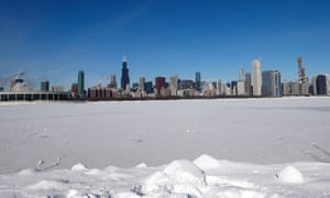 Steam rises from the buildings as Lake Michigan is covered in ice and snow