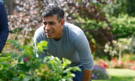 Rishi Sunak studies some plants during a visit to a public park in Bexley, England over the weekend.