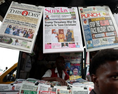front pages of newspapers reporting Trump's threat of military intervention in Nigeria at a kiosk in Lagos