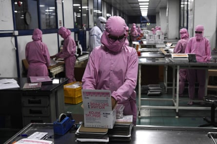 Workers pack syringes at the Hindustan Syringes factory in Faridabad. India’s biggest syringe manufacturer is ramping up its production, anticipating a surge in demand.