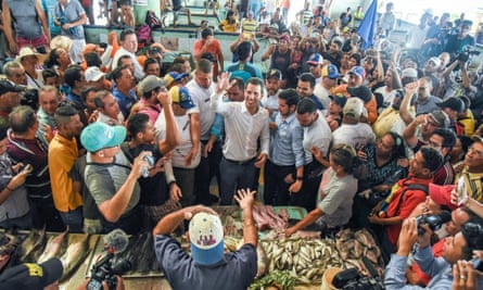Juan Guaidó has been touring his country in an effort to keep his campaign alive. Here he greets supporters at Los Cocos municipal fish market in Porlamar, Margarita Island.