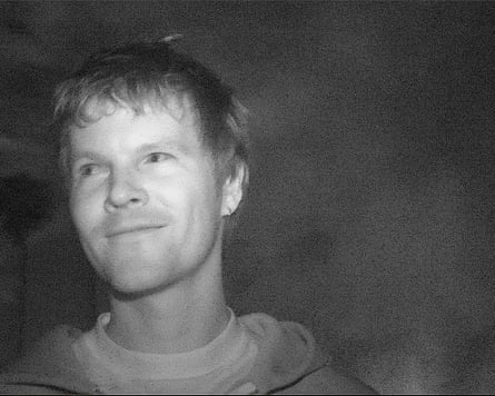 Man in black and white photo looks to side