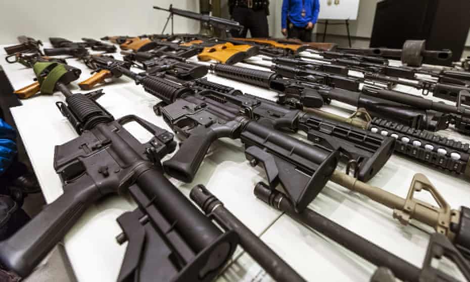 A variety of military-style semi-automatic rifles obtained during a buy-back program are displayed on a table at Los Angeles police headquarters in 2012.