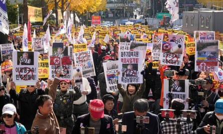 Protesters hold up placards