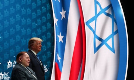 Donald Trump stands on stage alongside Sheldon Adelson before delivering remarks at the Israeli American Council National Summit in Hollywood, Florida, on 7 December 2019.