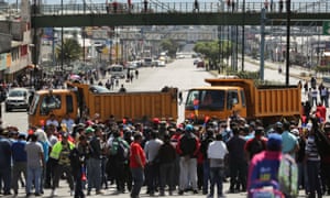 Trucks block main roads Monday during protests after Ecuador’s President Lenin Moreno’s government ended four-decade-old fuel subsidies.