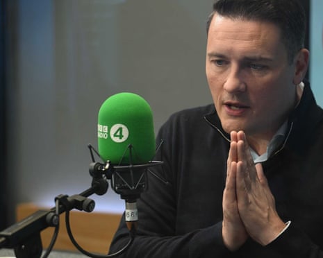 Wes Streeting, in front of a Radio 4 mic, clasps his hands together.