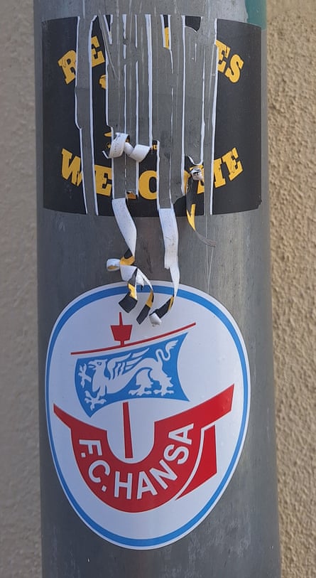 A ‘Refugees Welcome’ sticker defaced, Greifswald, Germany, 2025.