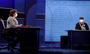 Deputies to the vice presidential candidates sit on stage in Salt Lake City, where plexiglass panels have been installed as additional protection against the coronavirus.