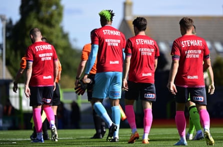 The Exeter City players take to the pitch in Darby Rimmer MND Foundation shirts in support of former player Marcus Stewart, before their September 2022 League 1 game at Forest Green Rovers.