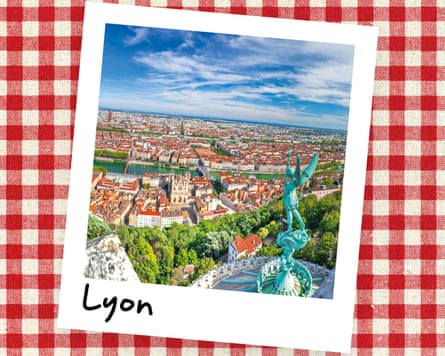 An instant photo of an aerial view of Lyon, with a statue in the foreground, against a red gingham background.