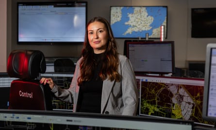 The National Grid’s Jemma Staley, standing, in a room full of screens.