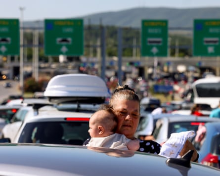 A woman and baby in queue of heavy traffic