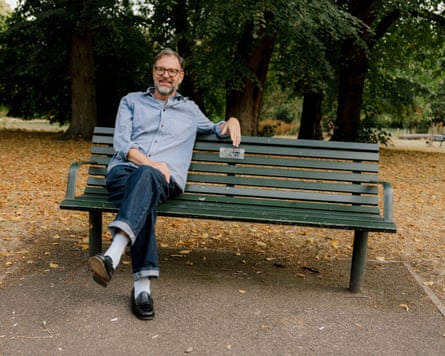 Tim Dowling sits on a London park bench, loafers in view