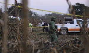 Authorities investigate the area where the helicopter carrying the governor of Puebla, Martha Erika Alonso, and her husband, Senator Rafael Moreno, crashed